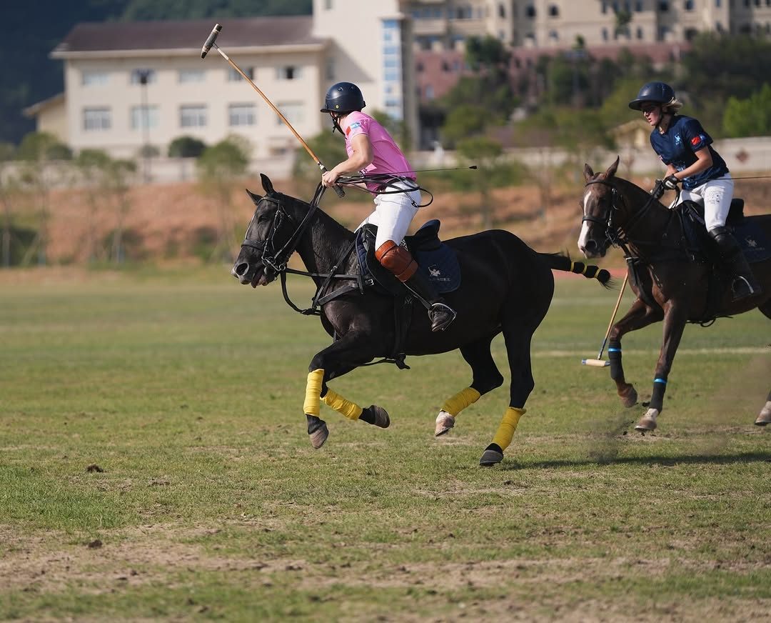A player swinging a mallet from horseback during a chukker